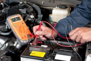 Technician testing a old inverter battery inside a lab setup